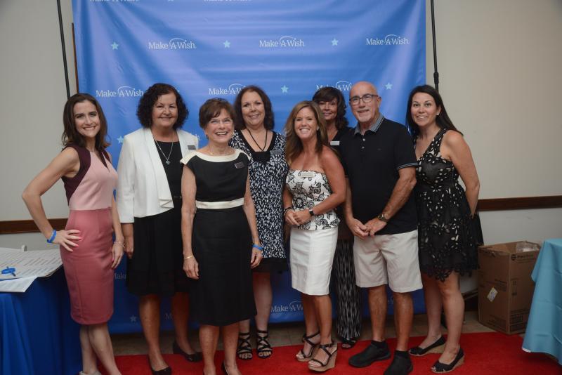 The Make-A-Wish event committee gathers in front of a Make-A-Wish backdrop. Shown are (l-r) Director of Communications Lorrie Miley; volunteer committee members Valerie Alia, Carolin Marshall and Lynne Singleton; event Chair Kim Grebe; volunteer committee member Lisa Kimmel; President and CEO Dennis Heror; and Communications and Engagement Manager Michelle Wall. STEVEN BILLUPS PHOTOS Make-A-Wish