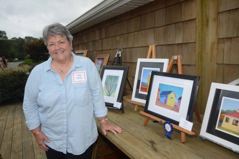Delaware Shore Artists group President Jane Duffy stands with her giclée prints. Autumn Splendor