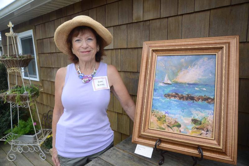 Jane Knaus stands with her Key West painting. Autumn Splendor