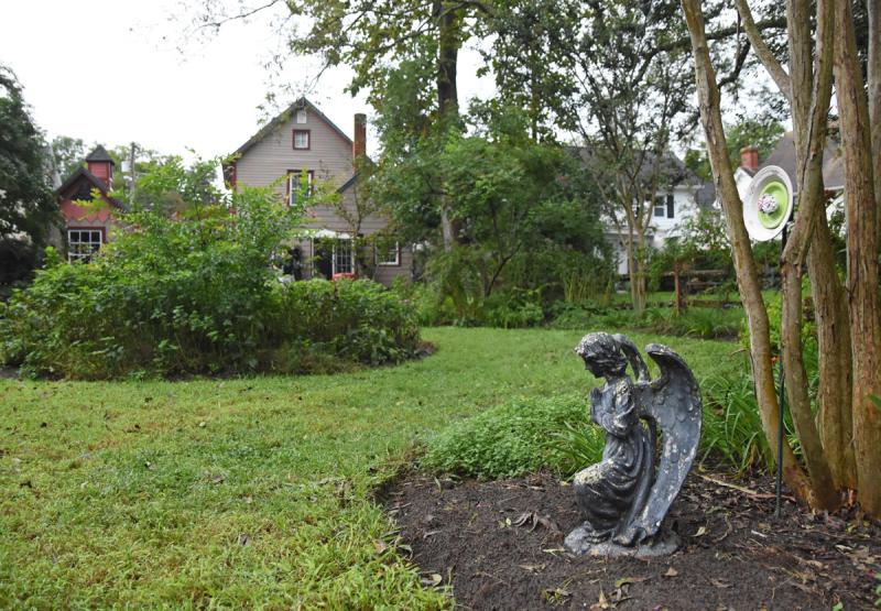 An angel sculpture looks over the back yard of John Kennedy.