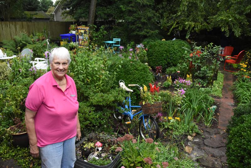 Kathryn Greig stands in front of her expansive backyard garden.