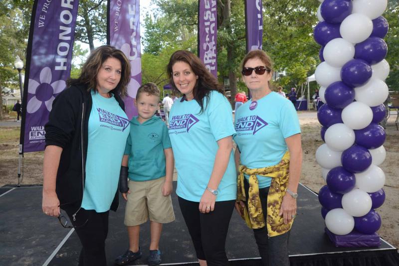 The chair and co-chairs for the WTEA gather on the stage for photos. Shown are (l-r) Chair Karen Dawson, Nolan Singo, and Co-chairs Amy Ferguson and Dawn Nash. Walk to End Alzheimers