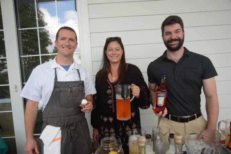 Chef Lion Gardner from Blue Moon holds a pastry that was paired with an Aperol Spirit cocktail. Shown with Gardner are Stephanie Hawke and Jamie Bossard from Southern Glazer Wine and Spirits. SoDel Wine and food