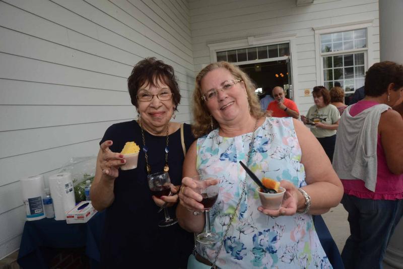 Sarah Gilmour, left, and Debbie Widdoes hold a pairing from Po’ Boys Creole and Fresh Catch Gumbo and Bogle Pinot Noir from Vintage Imports. SoDel Wine and food
