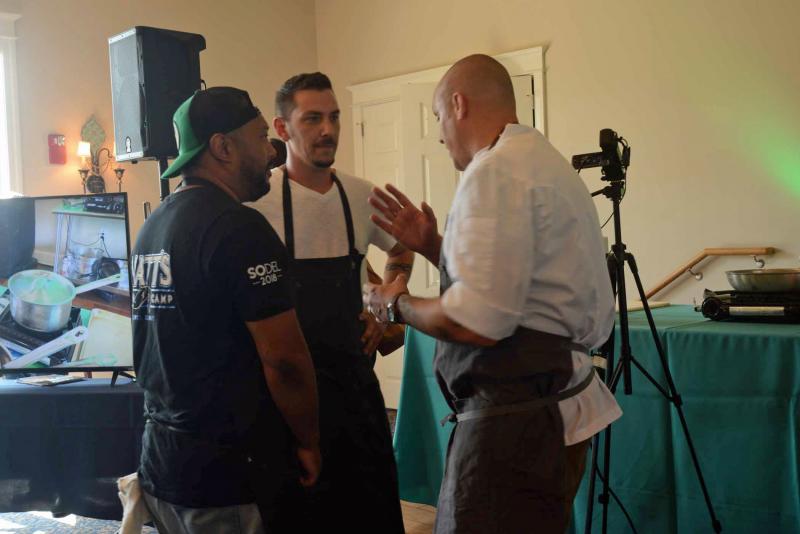 The Team Chef Showdown pitted Lewes chefs against Rehoboth chefs with specific ingredients. The Lewes chefs had a few minutes to plan their strategy before being separated with no communication. Shown conferring are (l-r) Chef Maaurice Catlett from Matt’s Fish Camp, Chef Ryan Cunningham from Bonz in Harrington, and chef and team Captain Matthew Kern from Heirloom. SoDel Wine and food