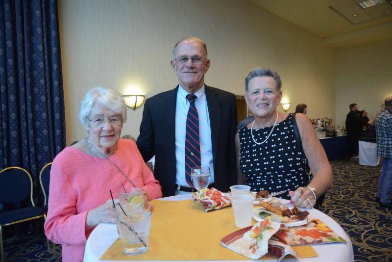 Socializing at the celebration are (l-r) Ann Meredith and Michael and Diana Robertson. All Saints’ Celebration 2018