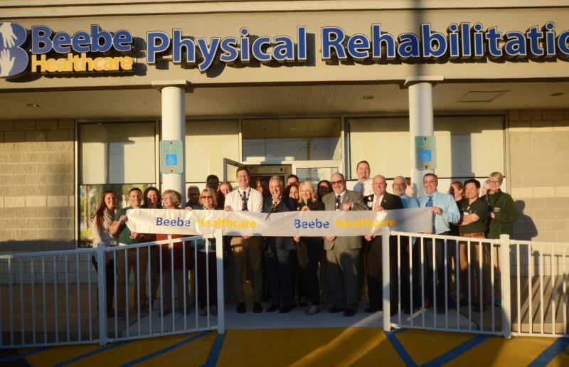A large group came outside for the ribbon-cutting ceremony. Shown are front row only (l-r) Brianna Eliowitz, Beebe Healthcare physical therapist; Andrew Clements, Beebe Healthcare physical therapy assistant; Lesley Nance, president of Beebe Healthcare Auxiliary; Judy Aliquo, president and CEO of Beebe Medical Foundation; Joseph Wayne, director of clinical operations for physical rehab, Beebe Healthcare; Joe DeRanieri, executive director of Beebe Healthcare Orthopaedic Service Line; Lt. Gov. Bethany Hall-Long; Rick Schaffner, executive vice president/COO; Tim Phelps, manager of physical rehab, Beebe Healthcare; Tom Protack, Beebe Medical Foundation; Dan Mapes, executive director of diagnostic and imaging, Beebe Healthcare; Steve Rhone, VP/CNO, Beebe Healthcare; Don Jung, Beebe Healthcare physical therapist; and Amanda Hunter, Beebe Healthcare speech language pathologist. Beebe Therapy Ribbon