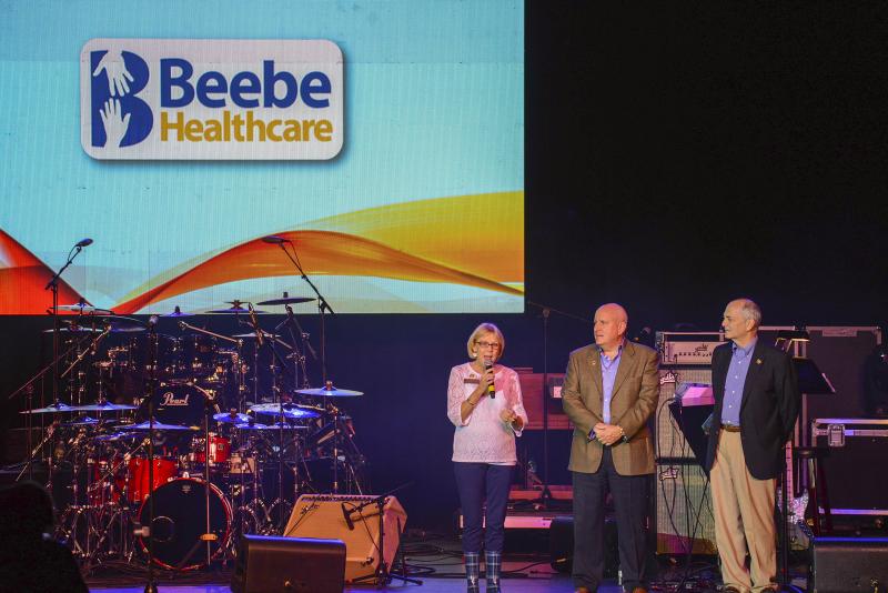 Beebe Medical Foundation thanks the Rehoboth Beach Jazz Festival board for its support of a $100,000 donation. Shown welcoming the crowd at the opening of the Jazz Festival at Cape Henlopen High School are (l-r) Judy Aliquo, president and CEO of Beebe Medical Foundation; Tom Protack, vice president of development; and Jeffrey M. Fried, President and CEO, Beebe Healthcare.