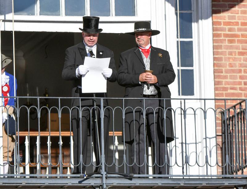 Georgetown Town Crier Kirk Lawson reads the vote tallies under the watchful eye of Sheriff Robert T. Lee.