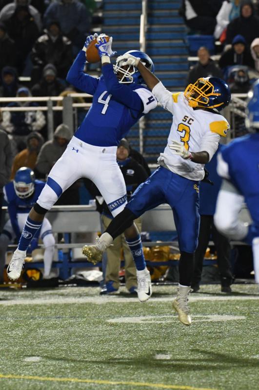 Dover’s Kylen Thomas, left, makes an interception in front of Central’s Javon Toppin, but it was negated on a Senators penalty.