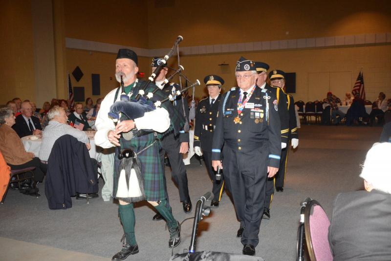 Bagpiper Henry DeWitt and Korean War Veterans Association and CHEER board member Walter Koopman lead the American Legion Honor Guard into the auditorium. CHEER Veteran Day