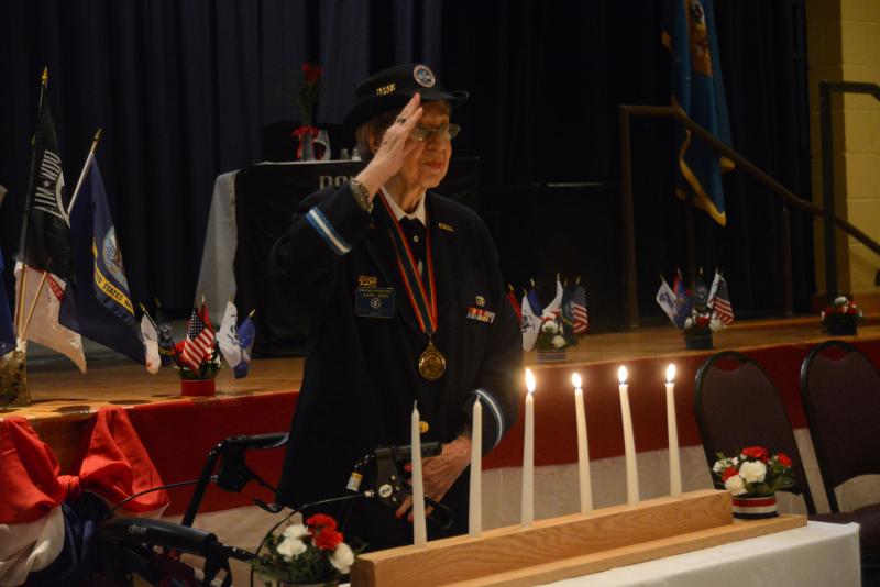 A candle was lit in remembrance of those who gave their lives or are missing in action. Each candle represents a different branch of the military. Saluting, after lighting the Air Force candle is Joann Sedei, vice president of the Korean War Veterans Association Chapter 1. CHEER Veteran Day