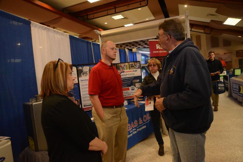 At the Tri-Gas and Oil booth, (l-r) customer service representative Chris Shinn and salesman Rusty Townsend discuss service with Richard Kendrick. Resort Home Fall