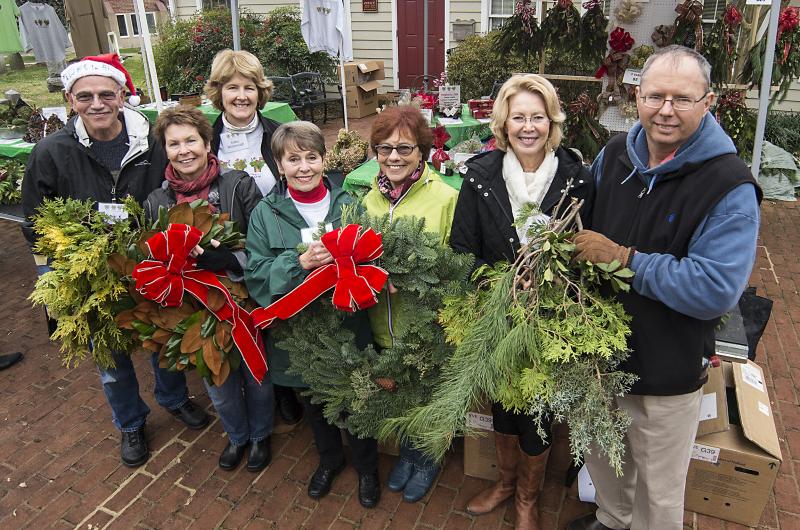 Lewes In Bloom members will be offering fresh greens and arrangements Dec. 1 during their annual Christmas Market in the courtyard of St. Peter's Church. Shown at a previous event are (l-r) Bud and Marilyn Vai, Kathy McDonough, Wanda Berrigan, Cecilia Friend, and Patti and Bill Ring. DENY HOWETH PHOTO