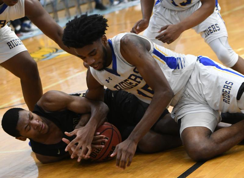 Hudson Catholic’s Daniel Rodriguez, left, battles for a loose ball with Caesar Rodney’s Shaft Clark.