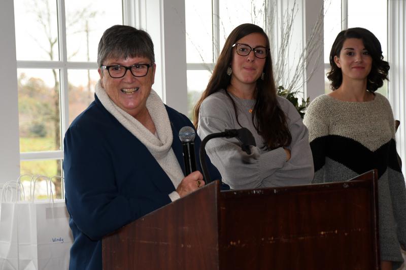 Assistant coach Debbie Windett speaks about the season as head coach Kate Austin and assistant Isabella Delario look on.