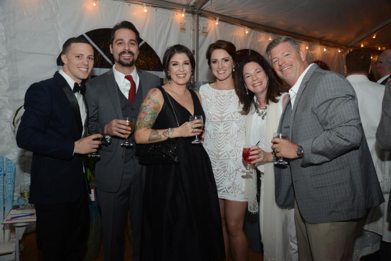 Enjoying the event in the heated tent are (l-r) Steven Finney, Rich and Dani Gaudiosi, Tila Hooven and Elizabeth and Michael Sanchez. Children’s Beach House Winter White