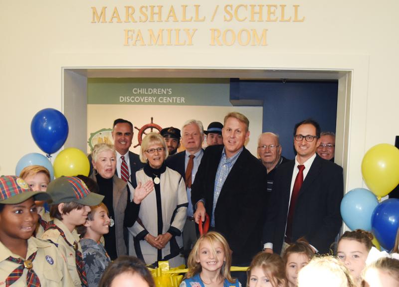 Surrounded by children at the ribbon cutting ceremony are (l-r) Libby Owen, chair of Lewes Historical Society; Sen. Ernie Lopez, R-Lewes; Ilona Holland, children’s book author; Andrew Lyter, LHS; Lewes Mayor Ted Becker; Marcos Salaverria, LHS; Preston Schell, donor; Capt. James S. Roberts, donor; Mike DiPaolo, LHS, executive director; and Capt. Steve Roberts.