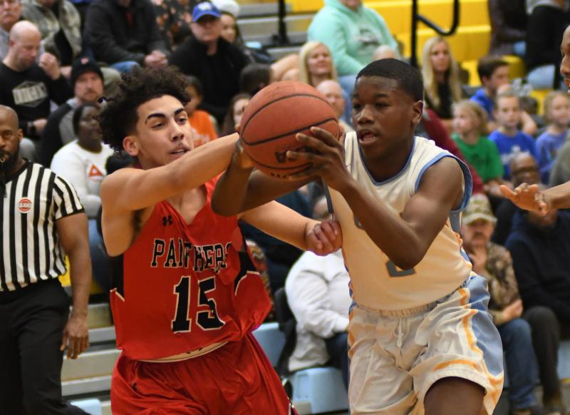 Cape’s Ja'Vaughn Burton, right, battles for a loose ball with Polytech’s Anthony Ellingsworth-Conde.