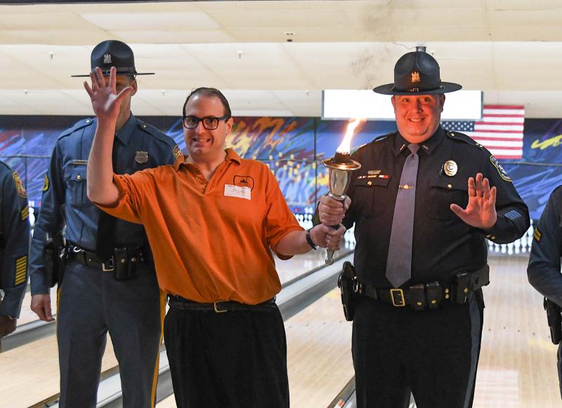 Ben Jacobs of the Wizards carries the Special Olympics torch with Harrington Police Captain Earl K. Brode.