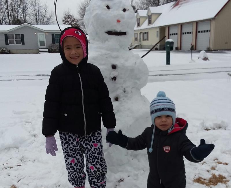 Laila and Micah Furniss from Lewes show off their snowman.