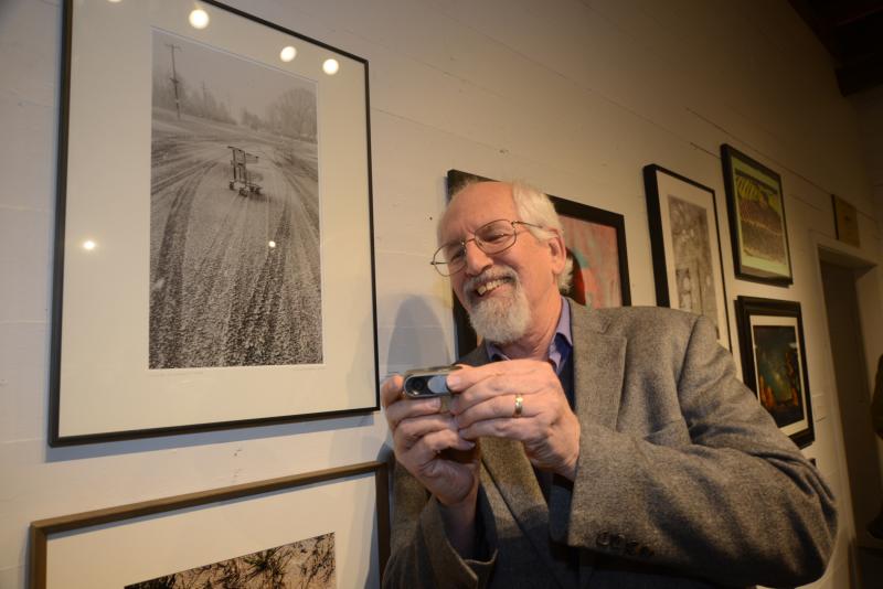 Showing the camera that was used to make his image, “Outside My Comfort Zone,” is Danny Schweers from Arden. RAL Juried Photo exhibit