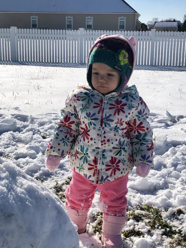 Finley Pentoney enjoys playing in the snow for the first time. Photo by Erica Pentoney.