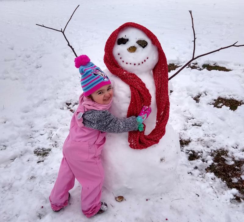 Alaina Rivera in Millsboro gives her new pal a hug.
