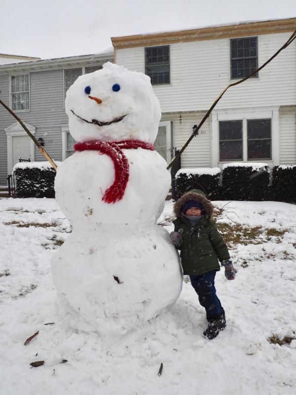 That’s a big snowman! Benjamin Pollard with Frosty (built by his dad, Ryan Pollard) in Milton.