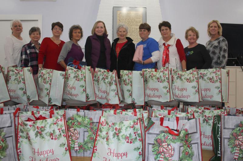 VIA holiday gift-giving committee members pose with the gift bags they assembled. Shown are (l-r) Pat Jurewicz, Julie Lewis, Catherine Hutchinson, Carol Hall, Co-chair Mary Jane Deets, Co-chair Carolyn Billingsley, Carole Baker, Terri Klopp, Eileen Nixon and Kathy Bruffey. Not pictured are many committee members who participate but could not be present for the photo. SUBMITTED PHOTO