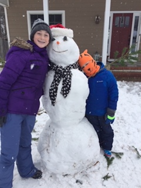 Sara and Cam Kilby pose with Carl the Snowman.