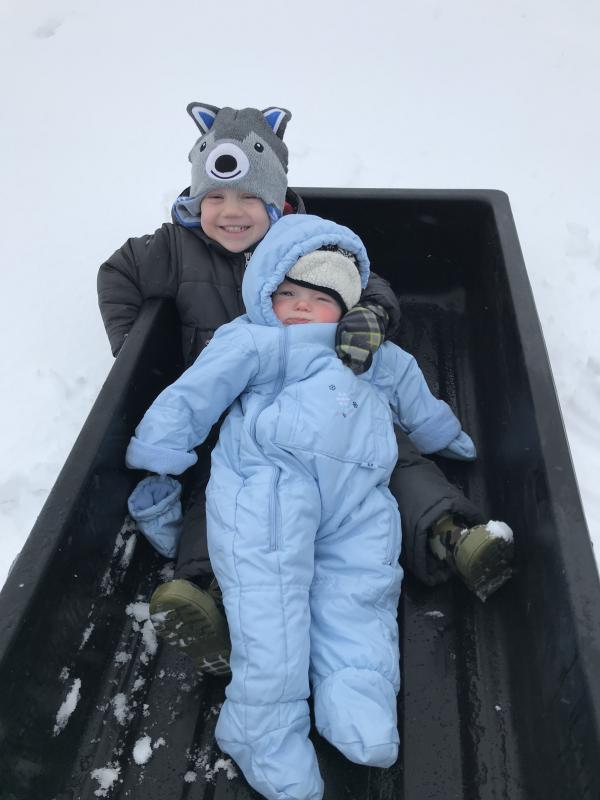 Wyatt Wilkinson holds baby brother Lincoln, who is enjoying his first snow.