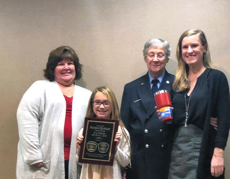 Shields Elementary third-grader Madison Handley, who received third place, is with (l-r) 1st Vice President of the Ladies Auxiliary of the Delaware Volunteer Firefighters Association and member of the Georgetown Fire Company Ladies Auxiliary Karen Workman, Caddie Joseph of the Lewes Fire Department and her teacher Maura Johnson.