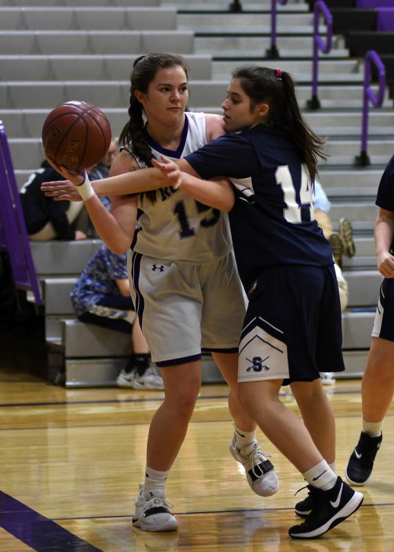 Royals freshman center Olivia Giltner gets the pass off despite getting fouled by Sabres sophomore Michaela Forster.