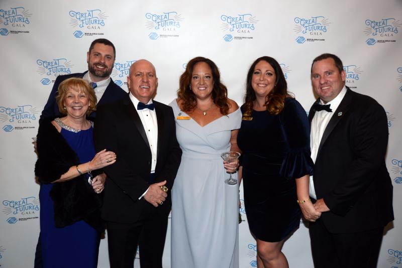 Gathered in front of the Great Futures Gala Banner are (l-r) Beebe Foundation President and CEO Judy Aliquo, Alex Miller, Beebe Foundation Vice President of Development Tom Protack, Milford Boys & Girls Club board member Nicole Silicato Miller, event co-chair Leanne Silicato Prosser and Chris Prosser. Great Futures Gala