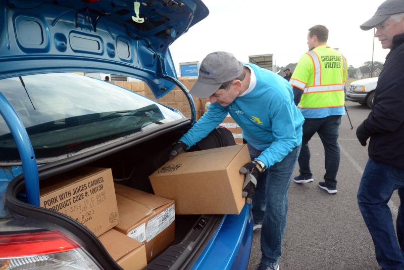 Chesapeake Utilities Corporation’s Senior Vice President Steve Thompson loads another case of pork items into a car. Food Bank Delaware