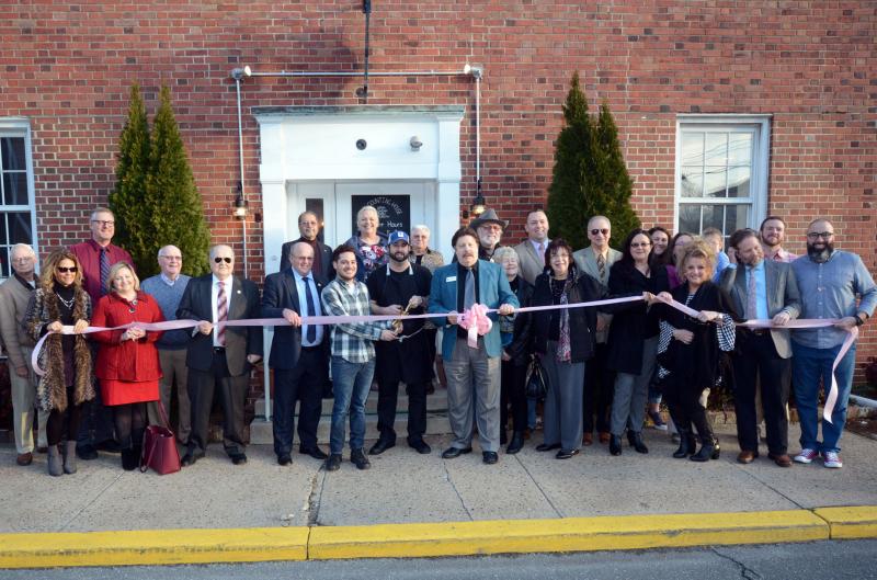A ribbon was cut in front of the Market Street entrance in a ceremony sponsored by the Georgetown Chamber of Commerce. Shown in back are (l-r) Don Kellicutt, Town Manager Gene Dvornick, Joe Conaway, Sunny Gyuani, Donna Koskey, Joann Conaway, Paul Steele, Sen. Brian Pettyjohn, R-Georgetown, Ken Cicerale, Jaime Lester Croce, Brooke Lester Darmstadter and Lee Darmstadter. In front are Lora Walinskas, Jennifer Antonelli, Georgetown Councilman Bob Holston, Mayor Bill West, Manager Miguel Batiz, Chef Bill Clifton, Georgetown Chamber President Anthony DelFranco, Barbara Steele, Sarah Gilmour, Georgetown Councilwoman Rebecca Johnson-Dennis, Laura Palmer, Bob Palmer and Joe Croce. The Counting House