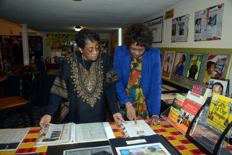 Browsing the black history display, collected by the Rev. Bishop A.D. Jones Jr., are the Rev. Deborah McCaffity of St. George AME, left, and the Rev. Pastor Margaret Jones of Trinity Faith. TFCC Black History