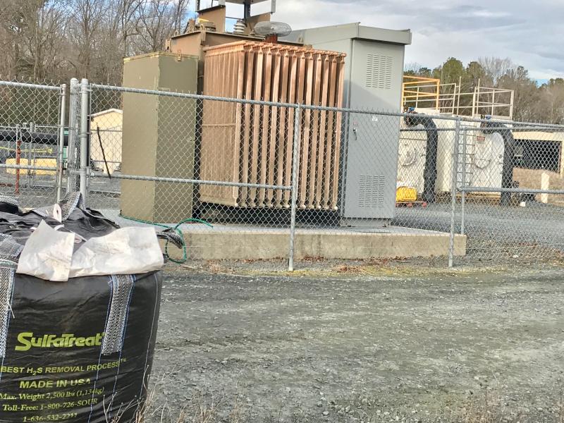 Ton containers of a special filtering material, foreground left, are placed in the methane gas collection receptacles (right, with the black gas intake pipes) to filter hydrogen sulfide out of the gas collected from the garbage cells. Hydrogen sulfide is generated by drywall deteriorating in the garbage stream and has to be cleaned from the methane gas so when it burns it won’t pollute the air.