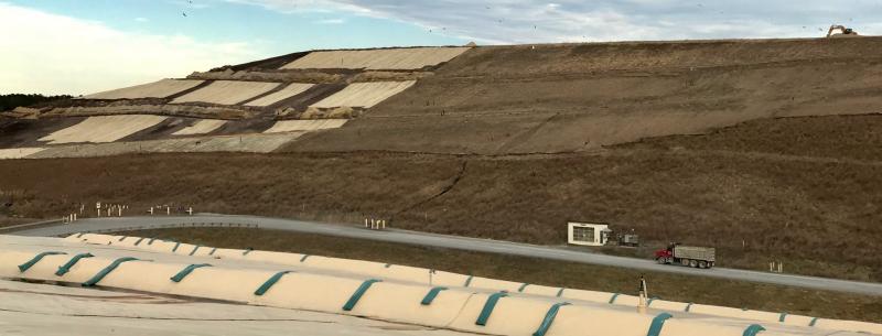 This photograph, from atop a previously capped cell, shows the immensity of cell number four, which is nearing capacity. The truck shows the scale of number four, much of which is already capped and vegetated, as well as portions that have been capped and are now waiting for newly seeded areas to take root.