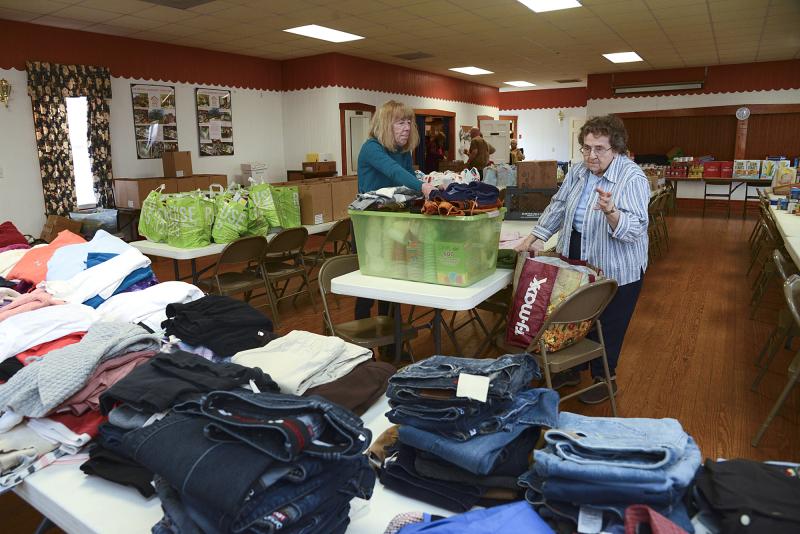 Sue Kinchy and Elaine Brown divide the clothes by size. “I rarely have clothes left over, but if there are any, they get donated to another charity,” said Brown.