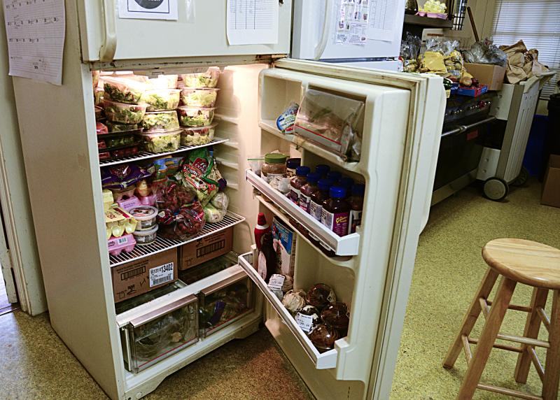 One of the shared refrigerators is stacked to the hilt. Since it is not an industrial model, it will often freeze the food that is stored in it.