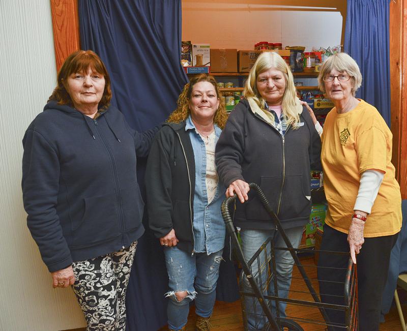 Donating a shopping cart to the pantry are (l-r) Barbara Biederman Holly Willey and Brenda Moffett, and Barbara Wright.