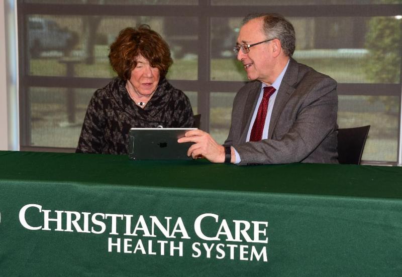 Judy Kirkland, left, Swank Leadership Council, Christiana Care, gets a demonstration from James Ellison, MD, endowed chair, Swank Memory Care Center, Christiana Care.