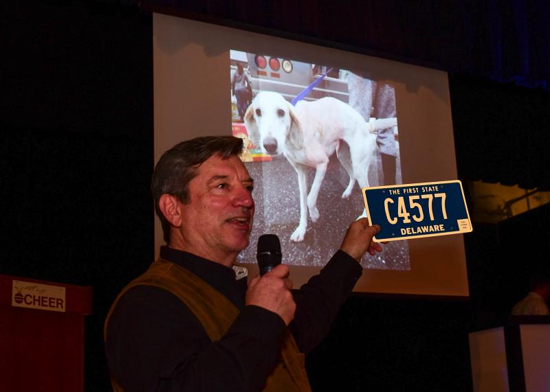Richard Bryan of Delaware Coastal Realty acted as auctioneer for the live auction and holds a four-digit tag donated by the DMV for the event.