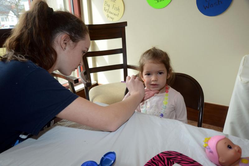 Facepainting is always a favorite activity at the Fun Fair. Dylan McGinley smiles as Ashley Betts from the Junior National Honor Society carefully paints. Bethel UMC Fun Fair