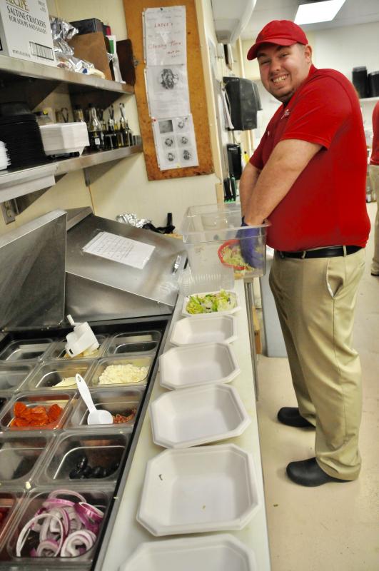 Hunter Wiswall is busy preparing salads in the Grotto Pizza Grand Slam kitchen near Lewes. RON MACARTHUR PHOTO