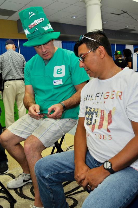 Pablo Marambao of Rehoboth Beach tries an innovative neck massage provided by Ryan Putney of Enovative Massage Technologies.