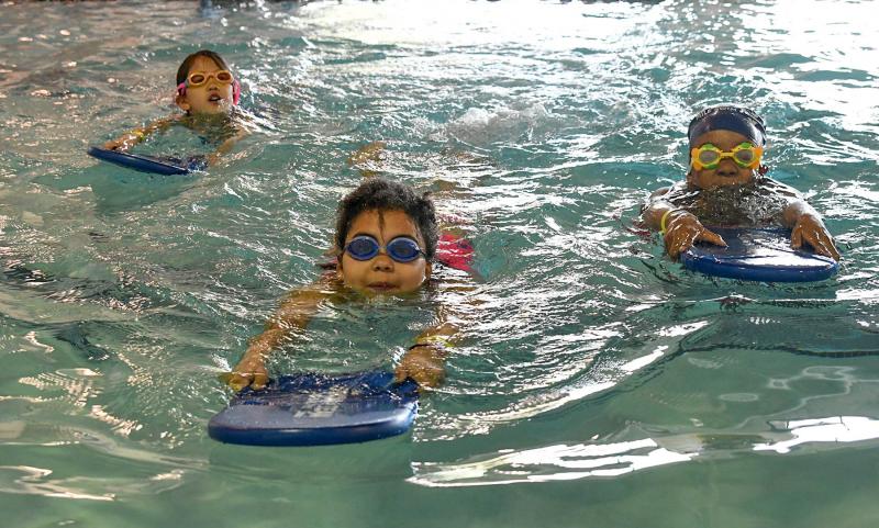 Speeding across the YMCA pool with their kick boards are (l-r) Zoe May, Lorraine Nickerson and Jada Thomas.