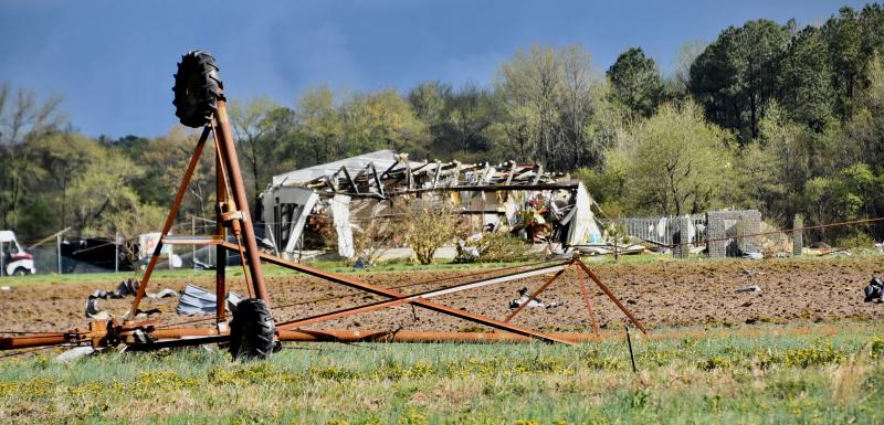 An irrigation system is turned upside down along Route 13 near Laurel. In the background is an Utz warehouse that was severely damaged. RON MACARTHUR PHOTO